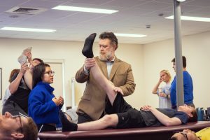 Daemen University PT professor works with students in lab